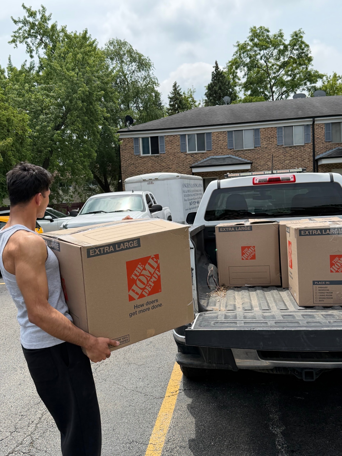 Loader carrying an extra-large moving box to a pickup truck