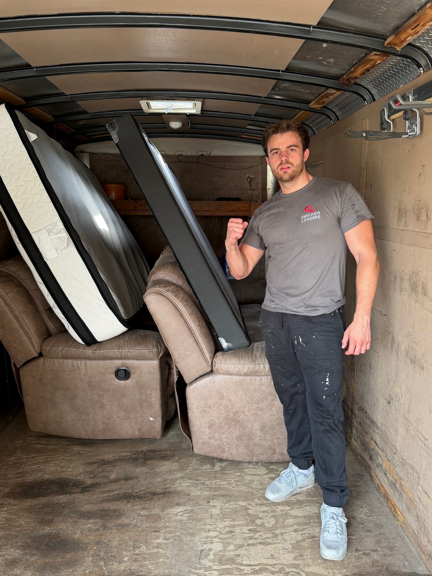 Loader inside a rental truck with a tightly packed load of furniture